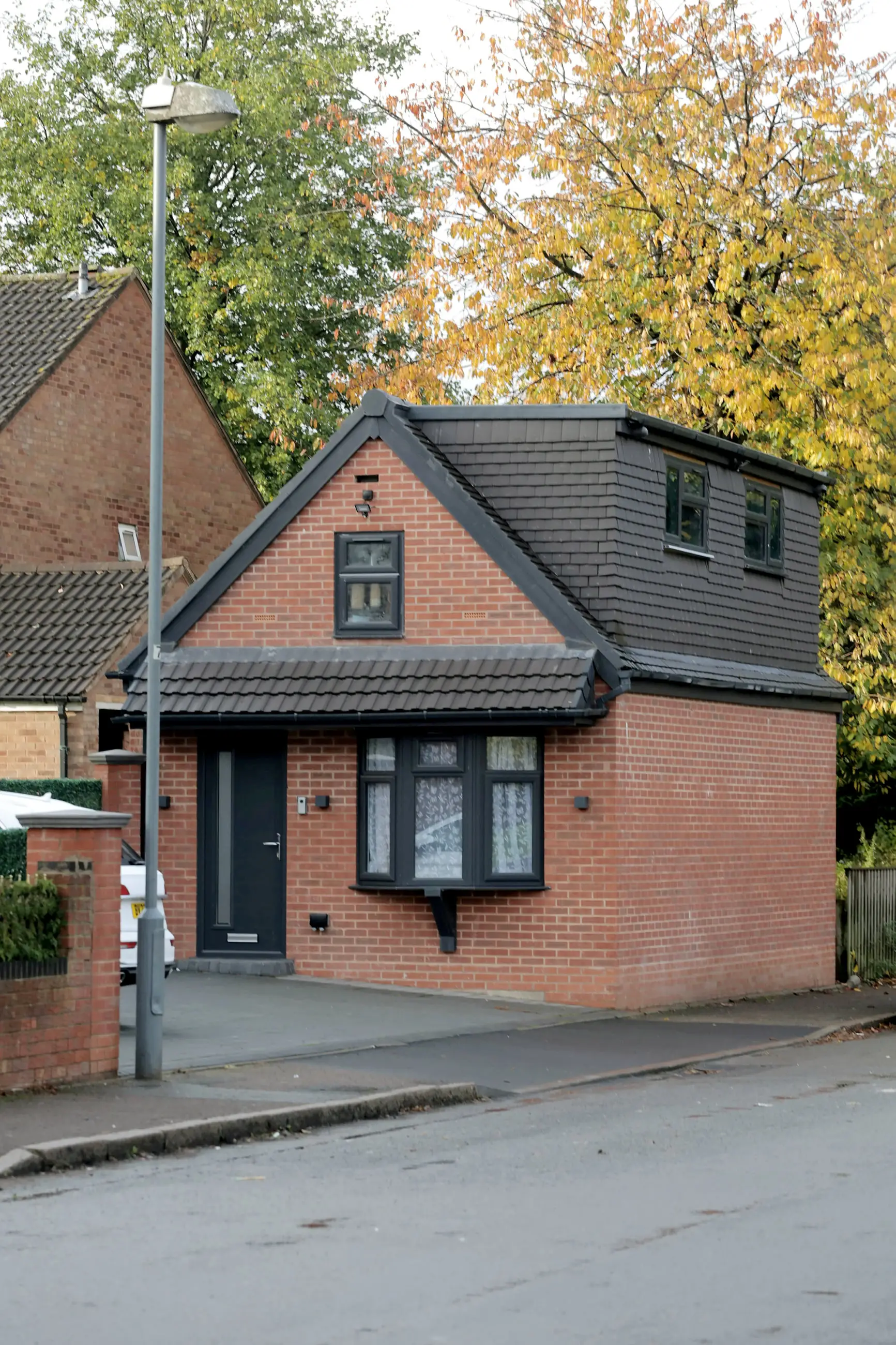 A man who built a detached house on his driveway without permission has finally had it partially removed.