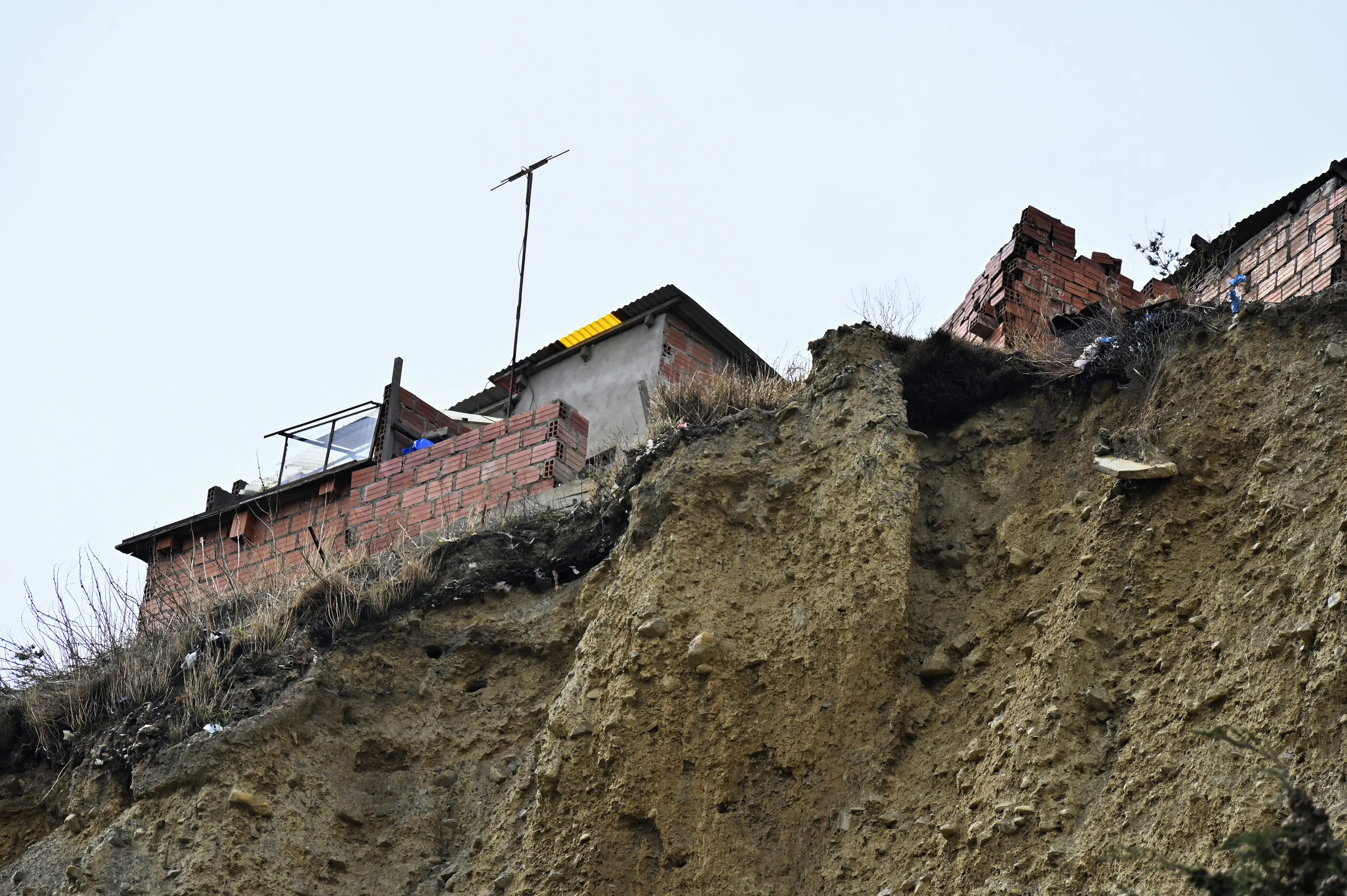 Experts have repeatedly issued warnings about the erosion of the cliff the homes sit on (AIZAR RALDES/AFP via Getty Images)