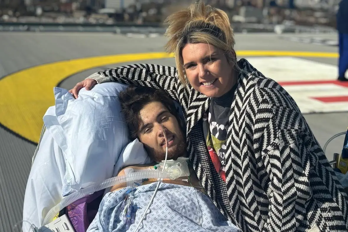 Riley with his mother after his time on life support in hospital (SWNS)