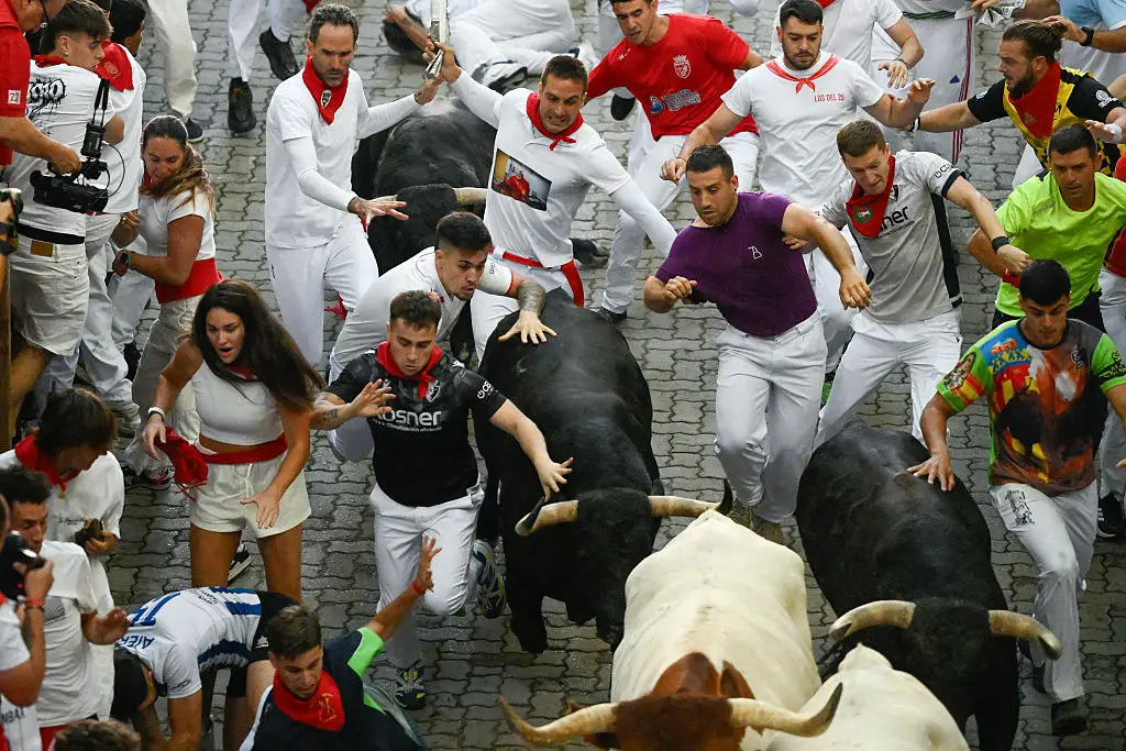 The festival sees people taking to the streets in front of the bulls (Miguel RIOPA / AFP via Getty Images)