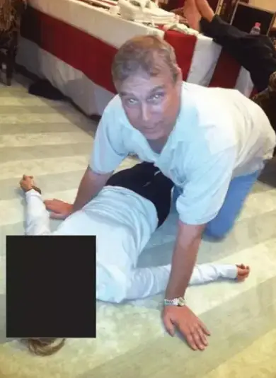 The latest documents included an image of Epstein on all fours kneeling over a woman (DoJ)