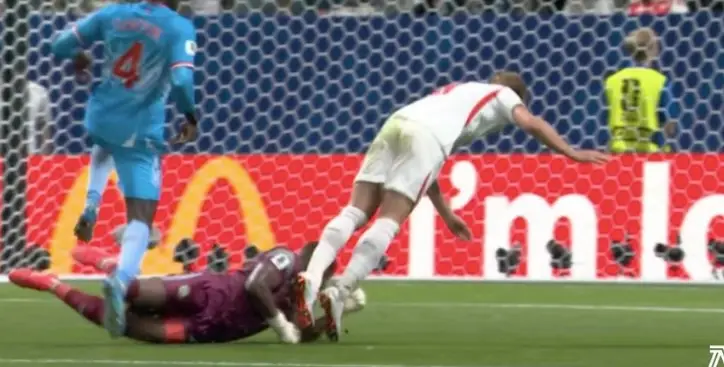 Kane took a tumble after clashing with the Congolese goalkeeper (BBC)