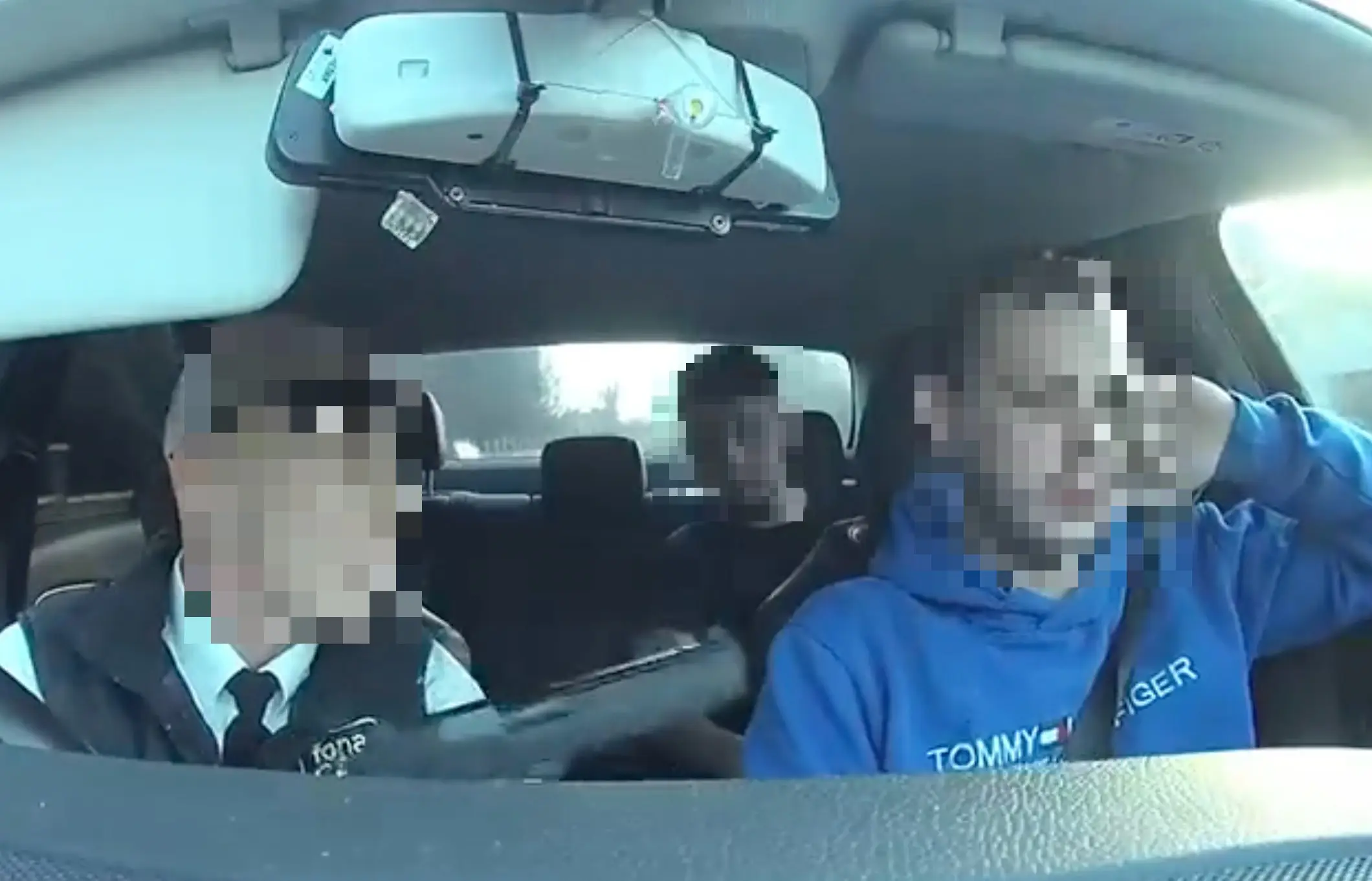 A taxi driver was seen holding a gun in a passenger's face.