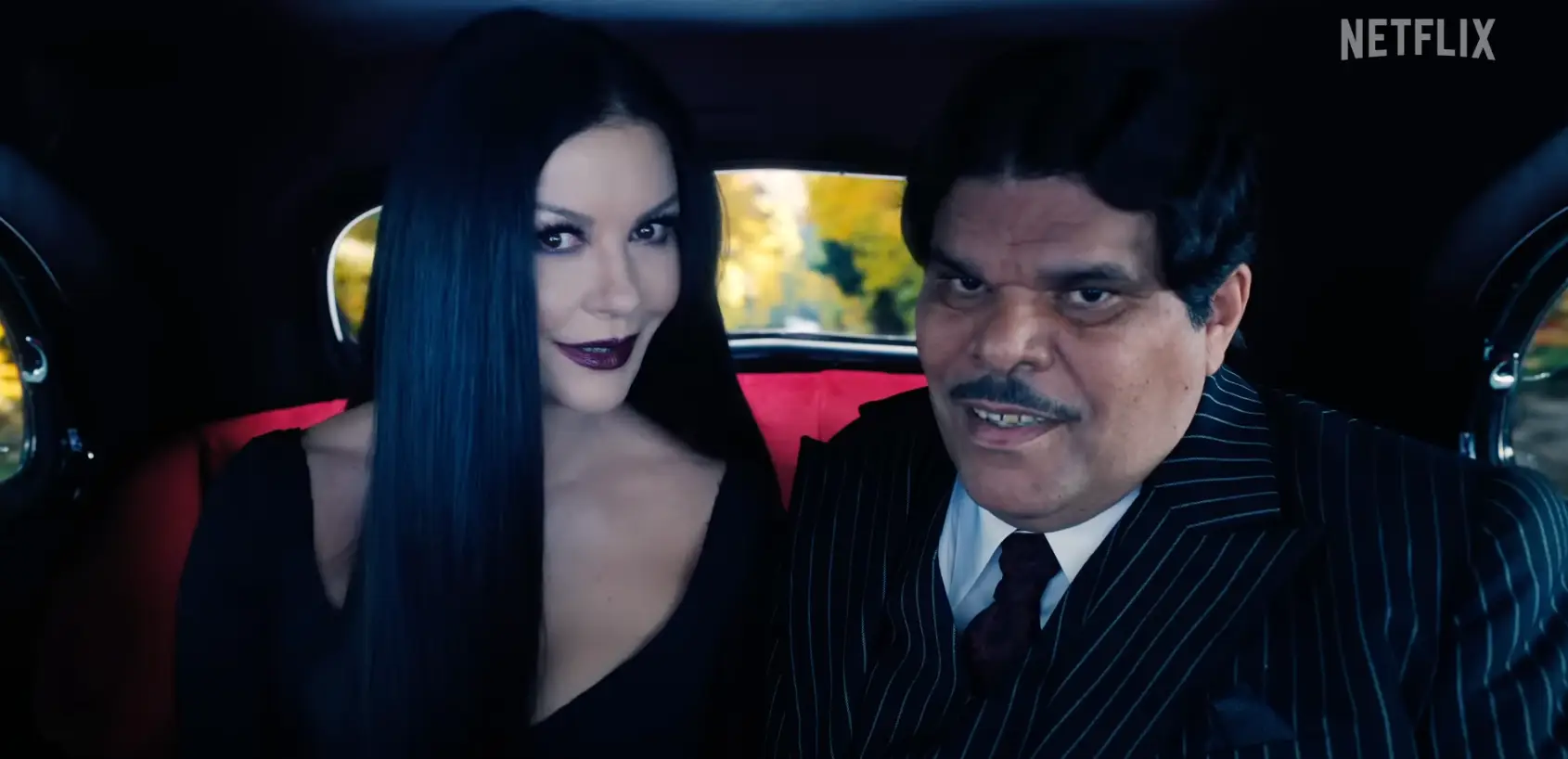 Catherine Zeta-Jones and Luis Guzmán as Morticia and Gomez Addams.