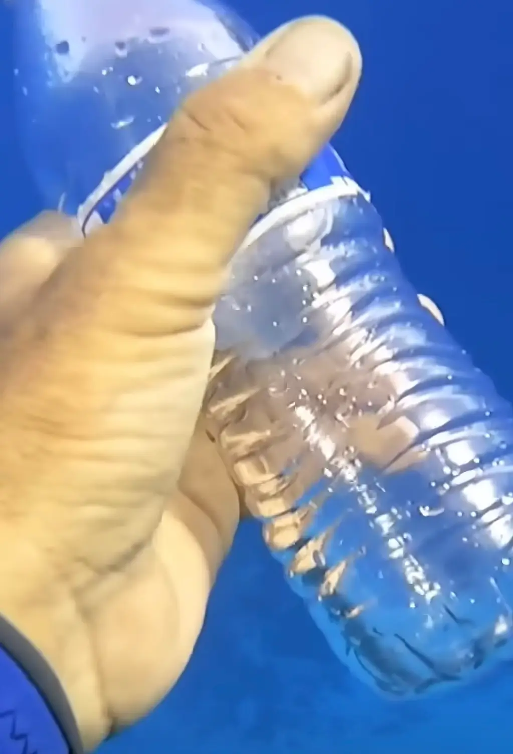 The underwater photographer showed how the bottle reacted to the change in pressure (YouTube/@justscuba-e7b)