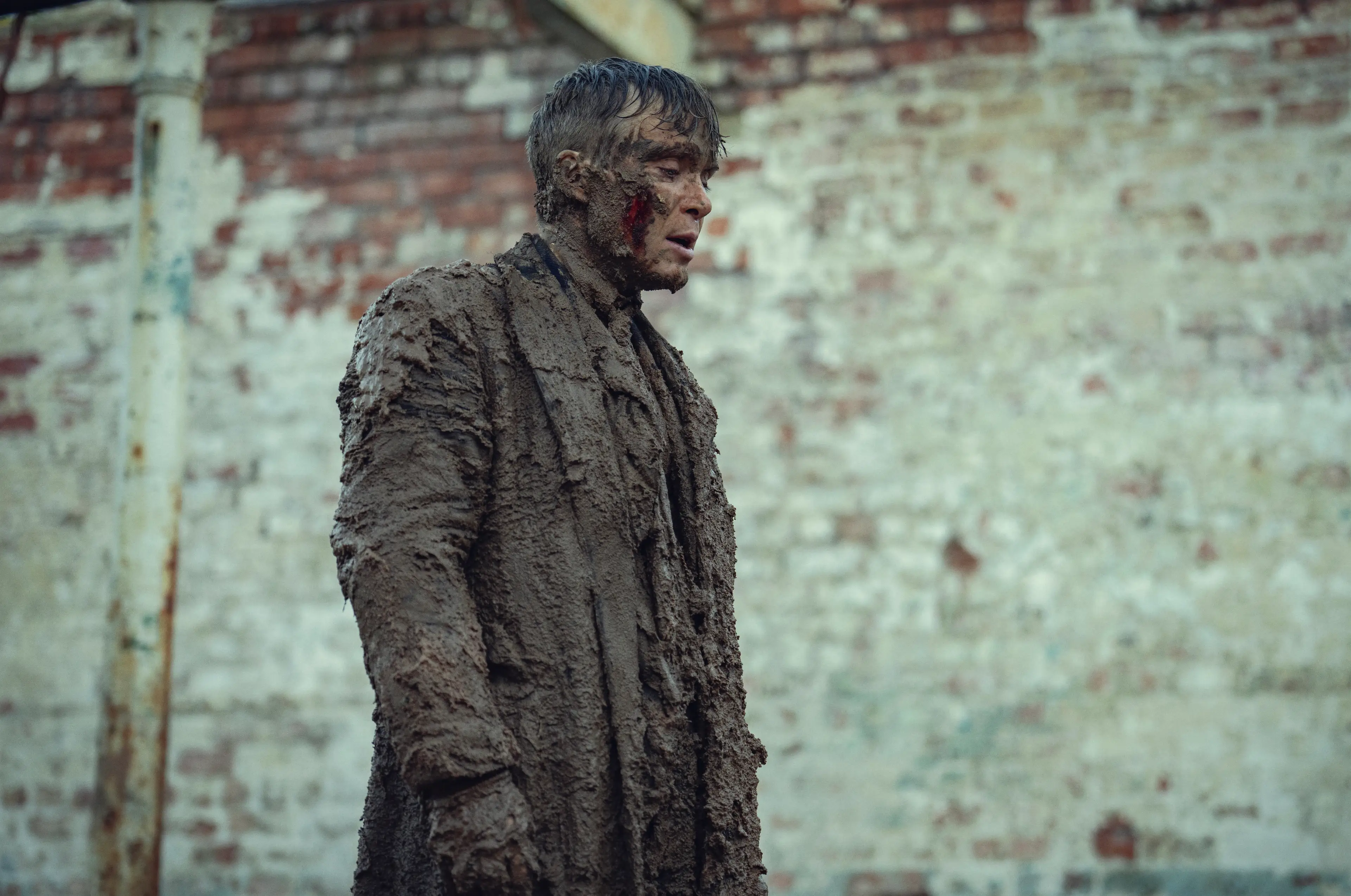 The Peaky Blinders protagonist told LADbible their costumes 'weighed as much as we did, or more' after rolling around in pig sh*t (Netflix)