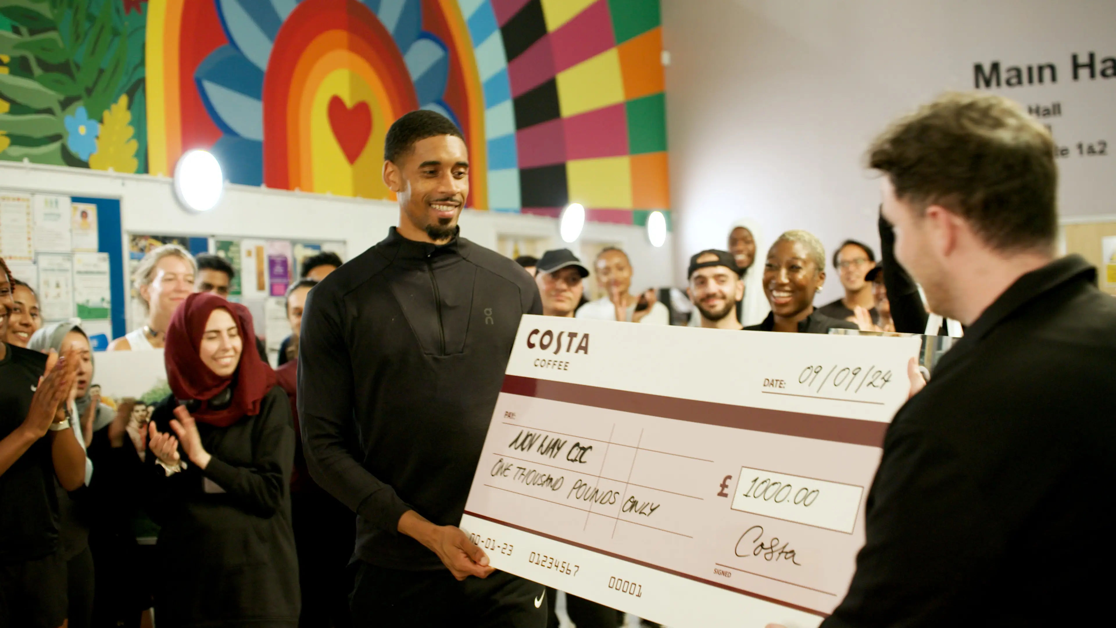 Leon receiving the cheque