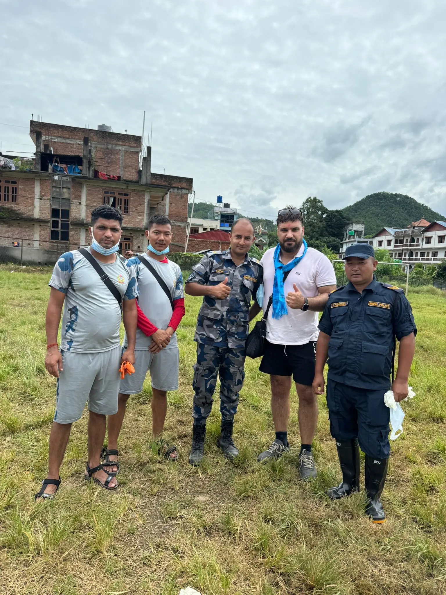 Alastair Chambers (2nd right) in Nepal after the flash floods (PA)