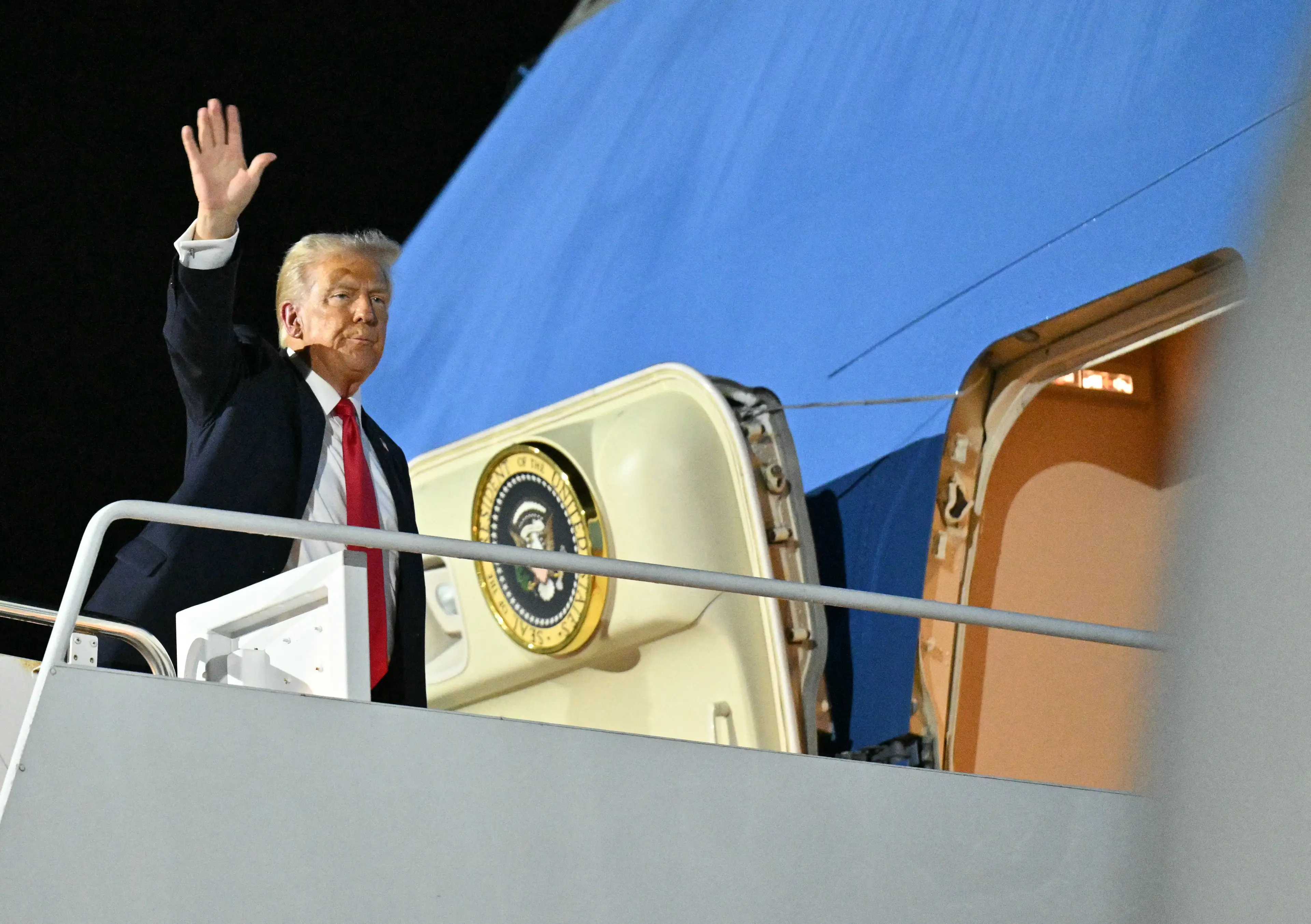 There was still plenty of time left in the game by the time Trump was boarding Air Force One. (ROBERTO SCHMIDT/AFP via Getty Images)