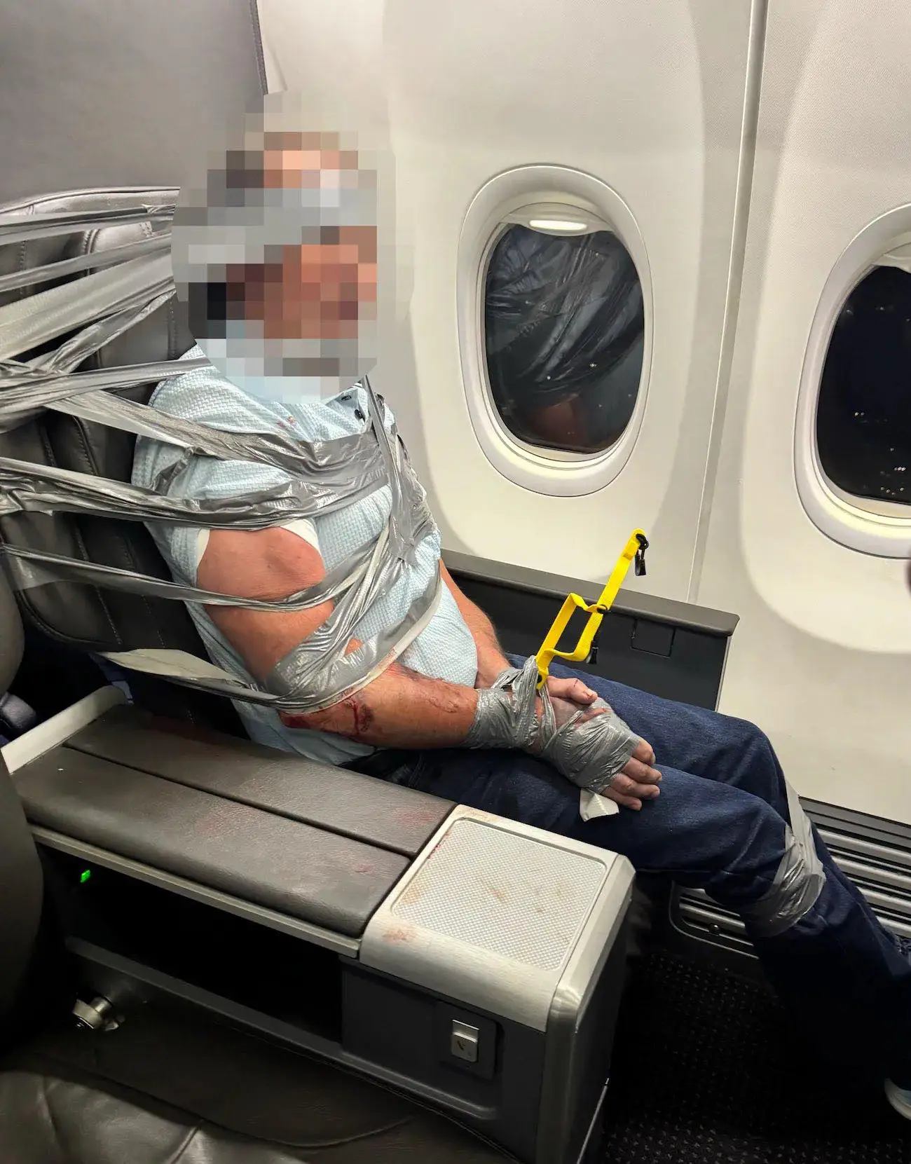 The flight crew duct taped the man into his seat (Instagram/Richard Olenick)