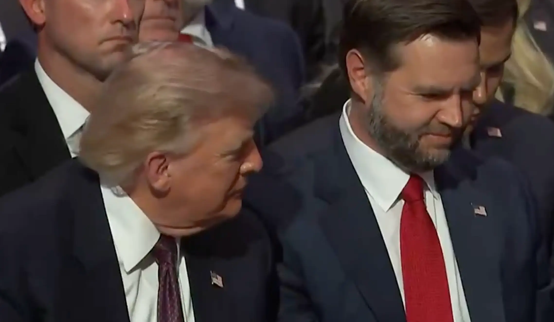 The pair appeared to be giggling during the service (X)