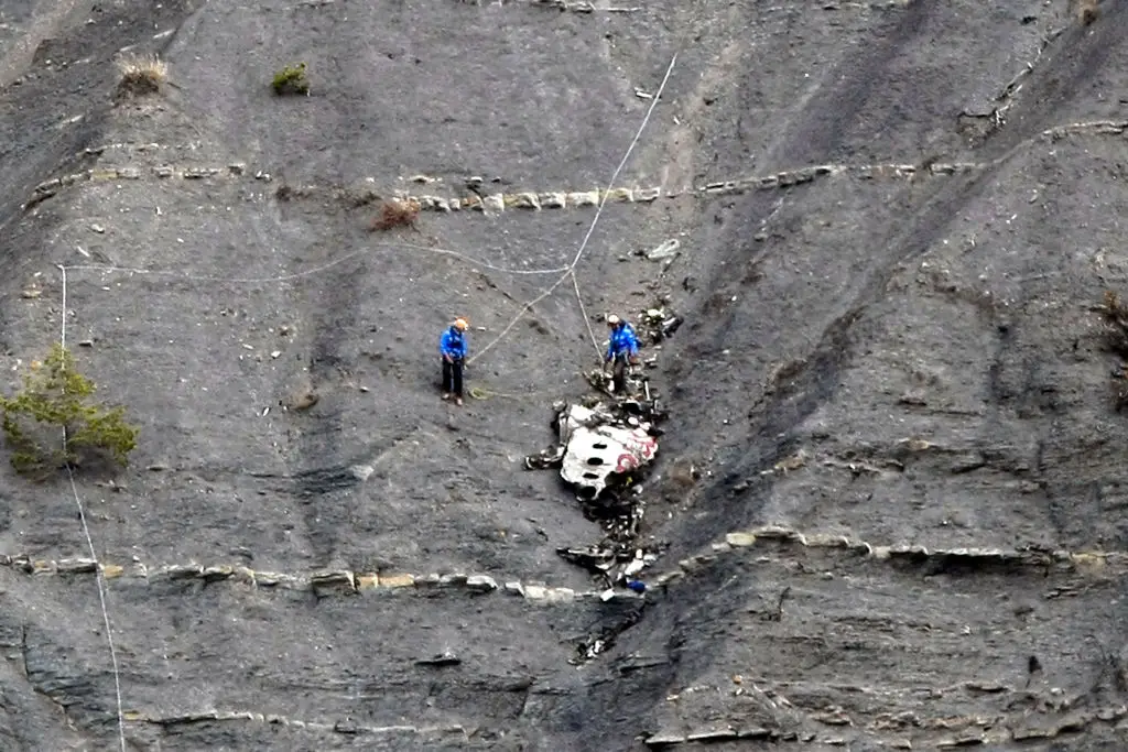 Search and rescue teams seen at the site of the crash (CLAUDE PARIS/POOL/AFP via Getty Images)