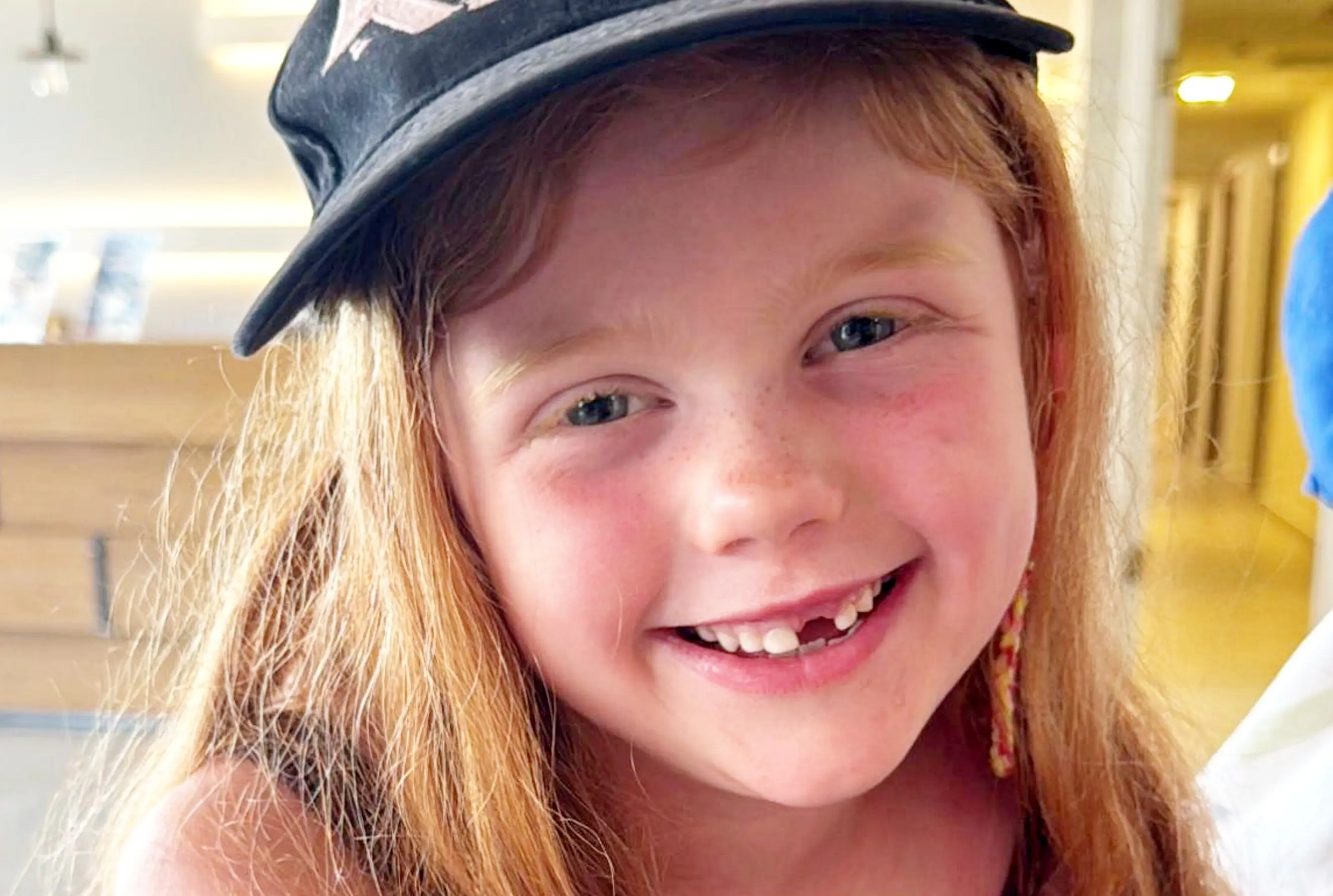 Addyson, 6, was sick while waiting in Rhodes Airport (SWNS)
