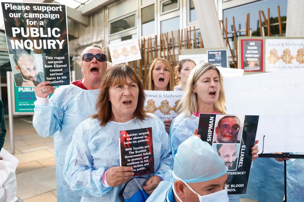 Campaigners pictured in 2023 calling for the inquiry into Eljamel (Jeff J Mitchell/Getty Images)