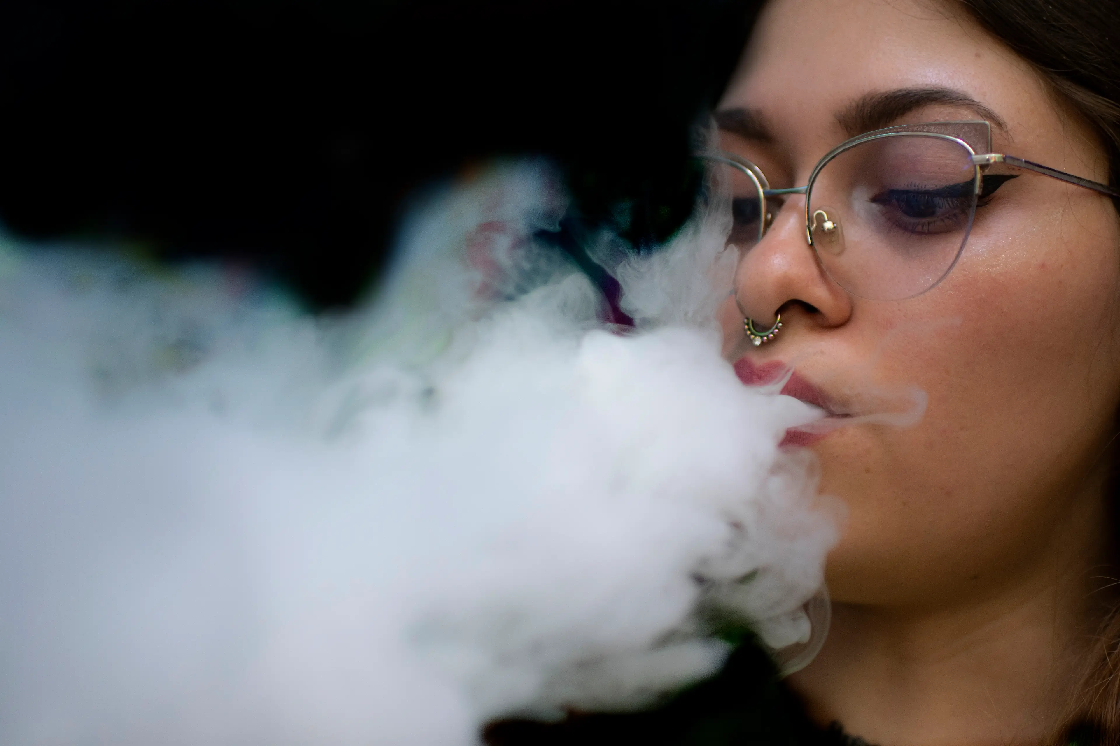 A woman exhaling after puffing on a vape (EZEQUIEL BECERRA/AFP via Getty Images)