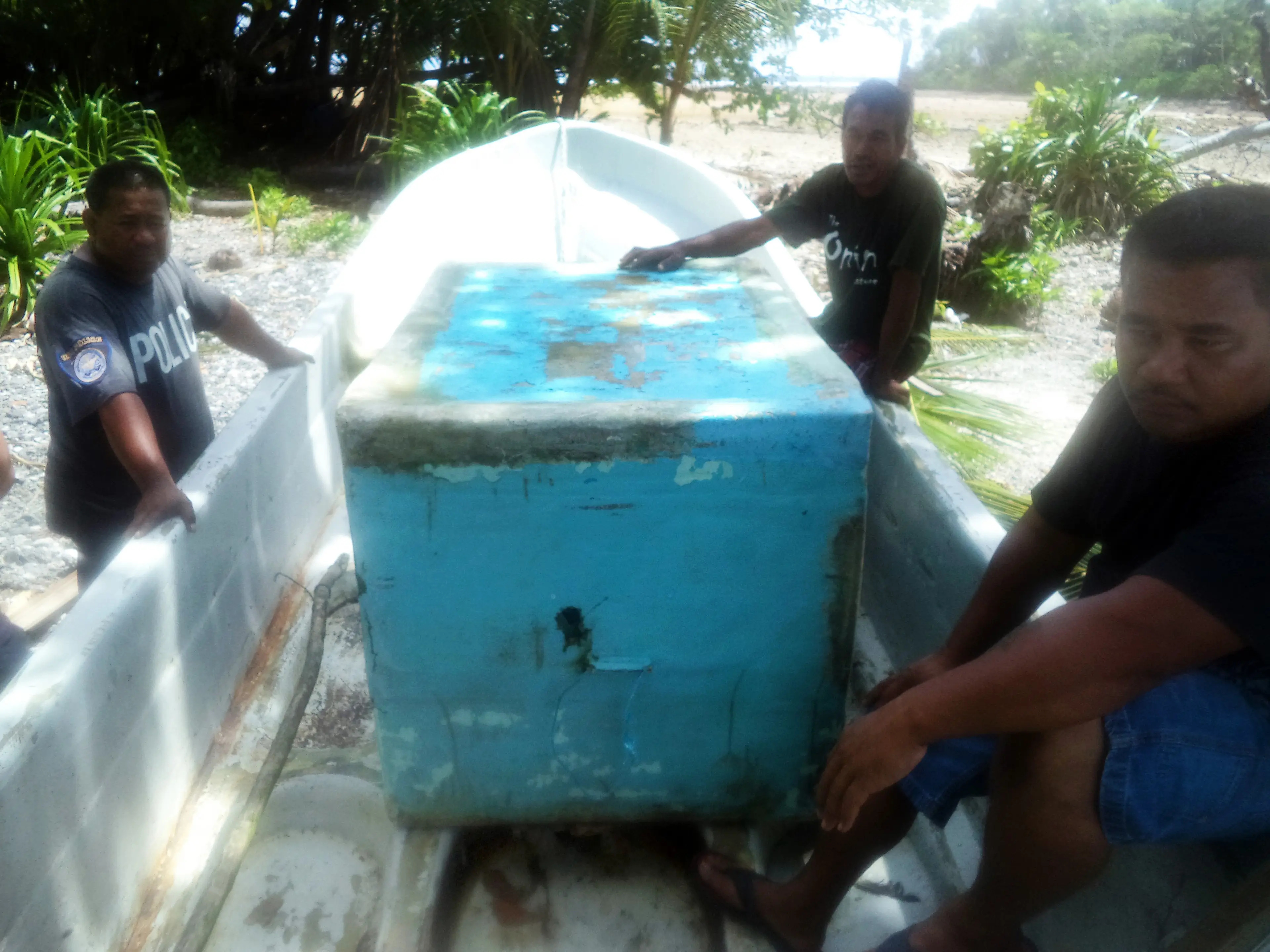 Alvarenga's boat and the icebox he huddled under for shelter, pictured after he made it ashore (STR/AFP via Getty Images)