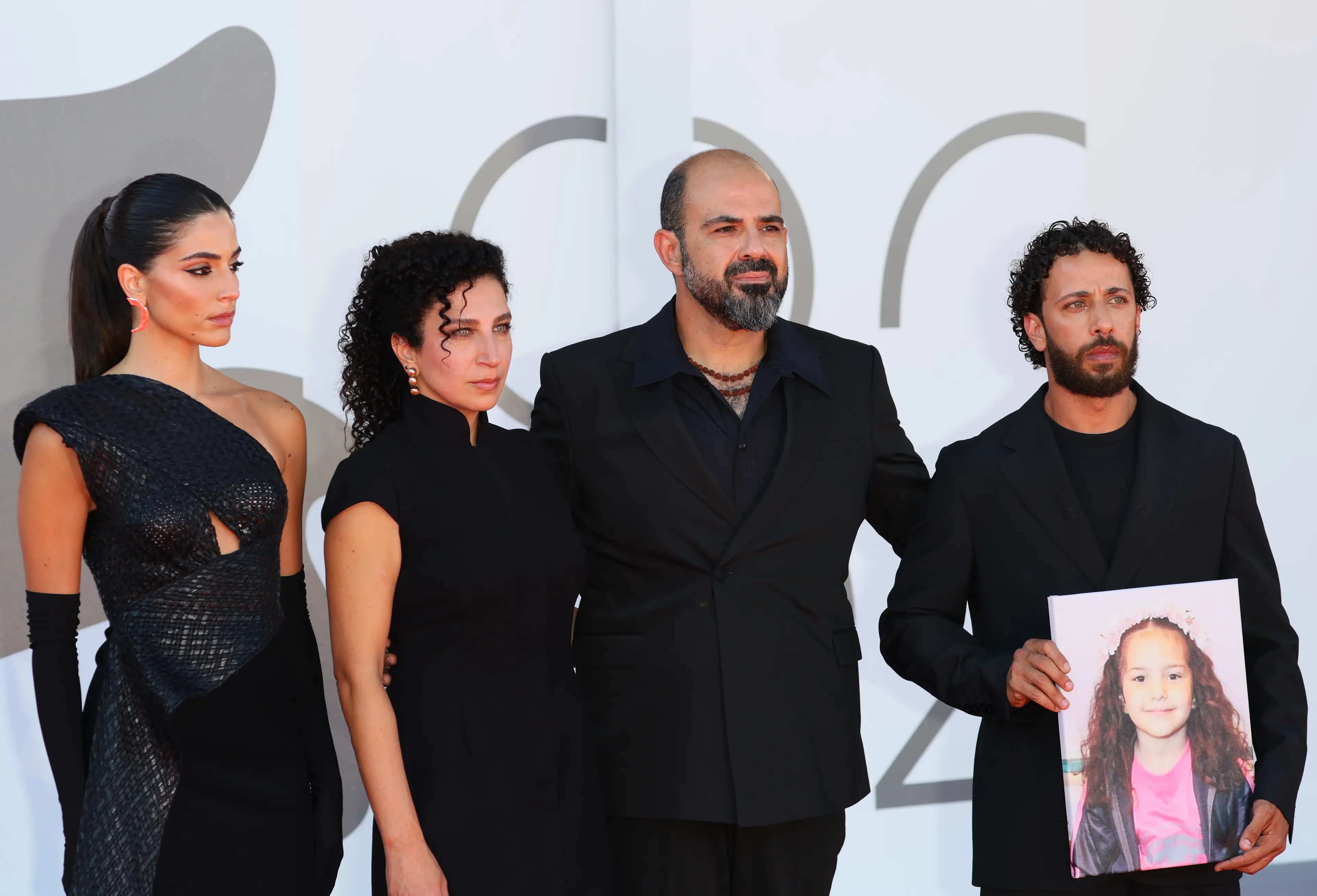 Motaz Malhees (right) holding a picture of Hind Rajab (JB Lacroix/FilmMagic)