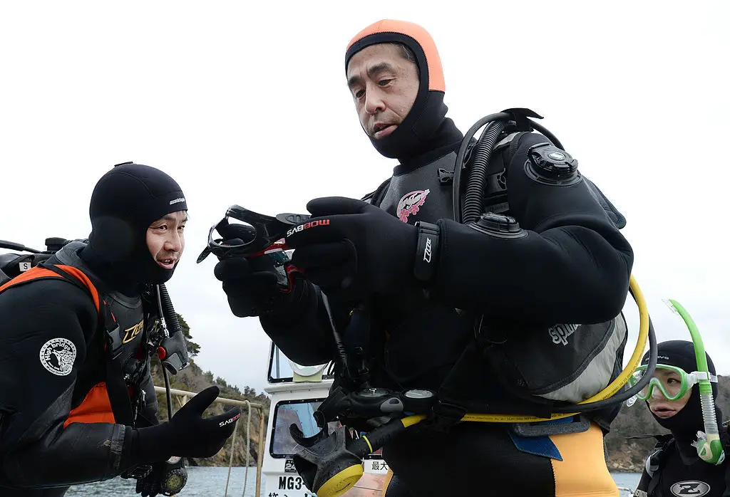Yasuo Takamatsu has been diving for more than a decade to search for his missing wife. (TORU YAMANAKA/AFP via Getty Images)