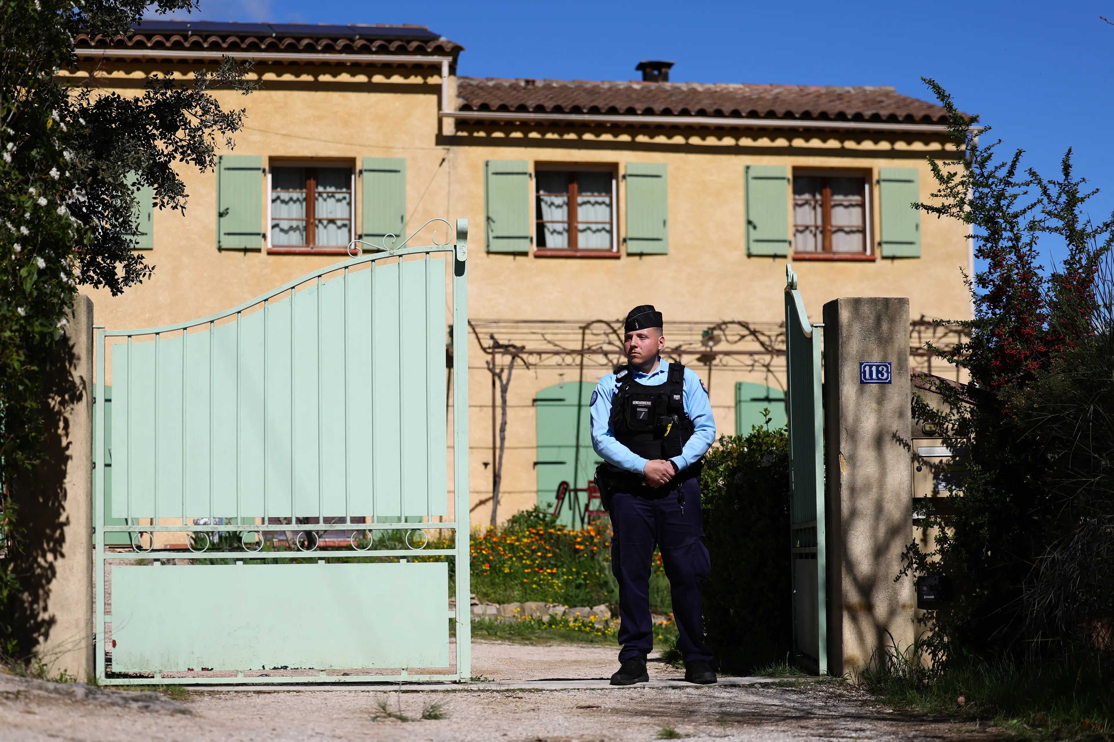 A police officer standing outside the house of Emile Soleil's grandparents (CLEMENT MAHOUDEAU/AFP via Getty Images)