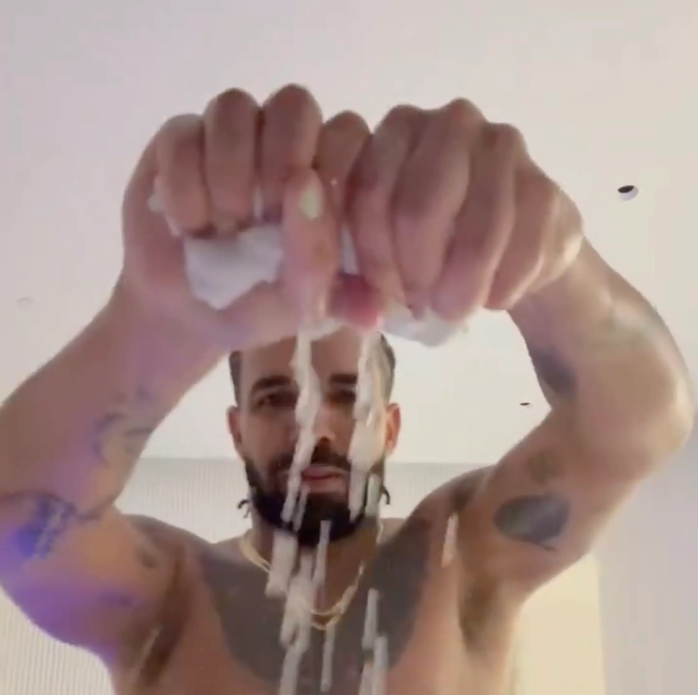 The rapper wrung out his sweat-soaked shirt in the short clip.