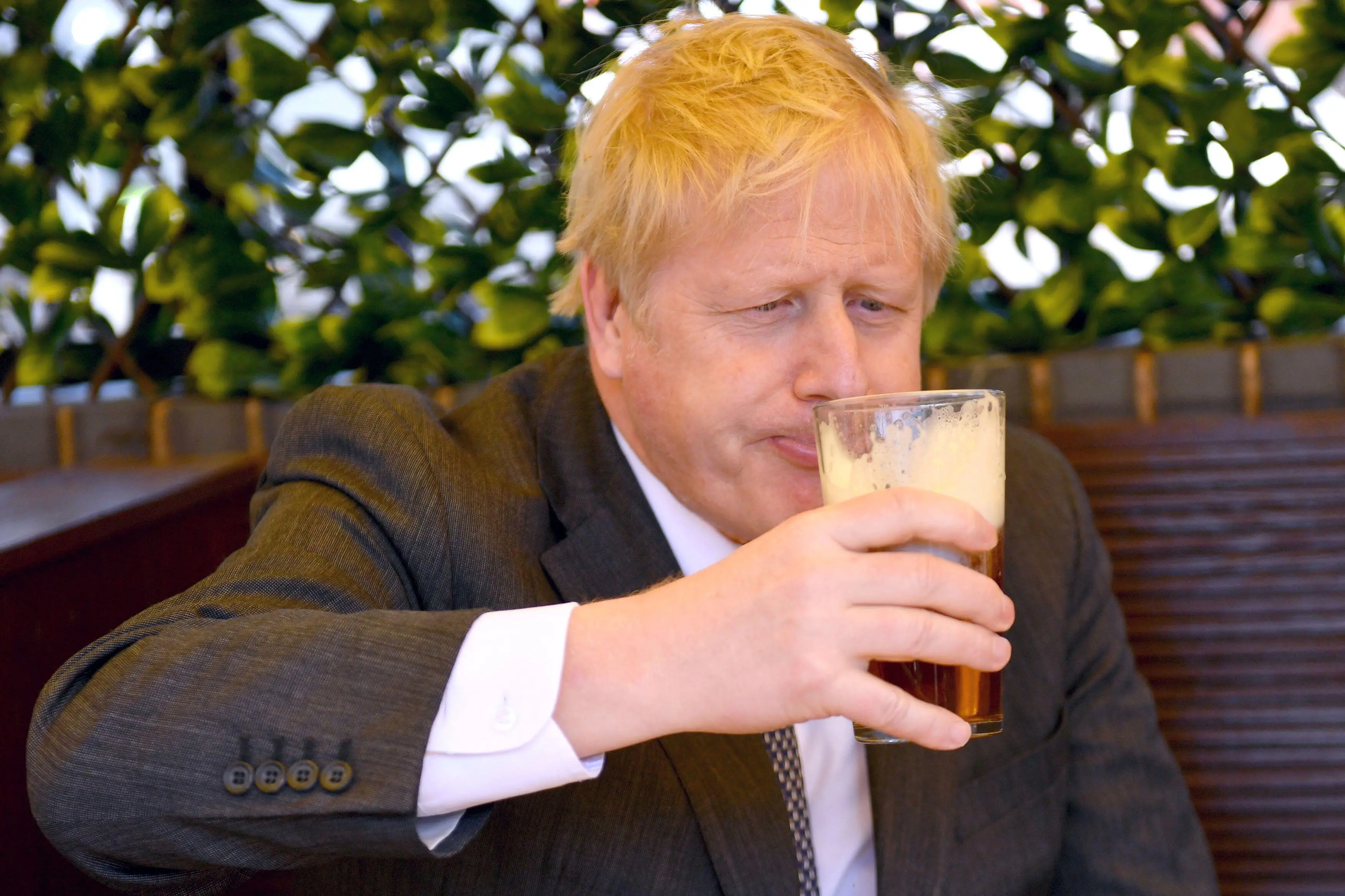 Boris Johnson drinking a pint.