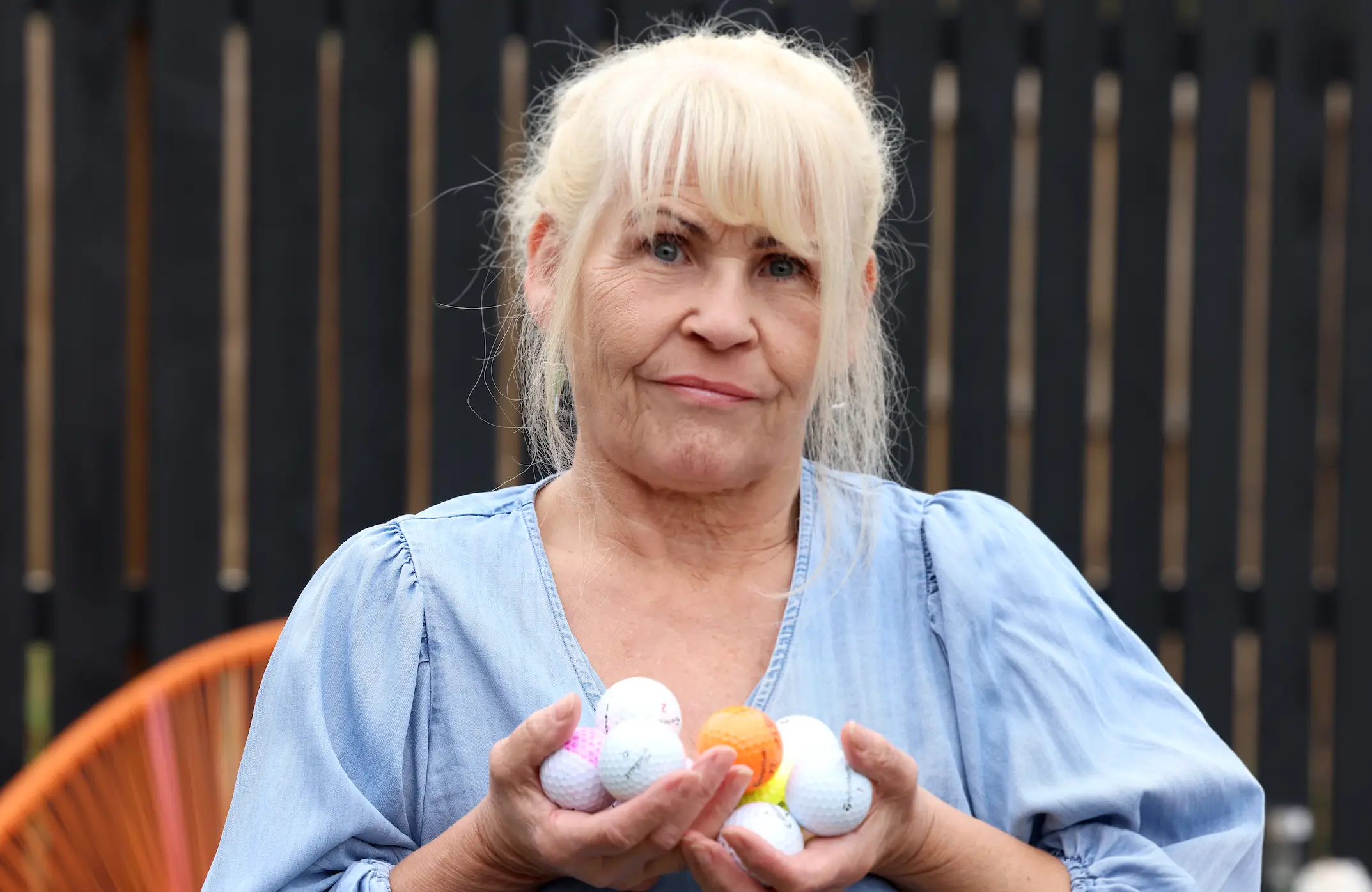 Stott shows off some of the balls she's collected from her back garden (Newcastle Chronicle)