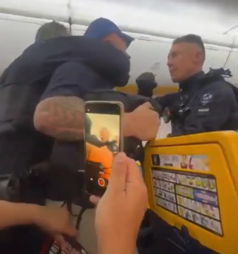 He was escorted off the plane (Anonymous via Storyful)
