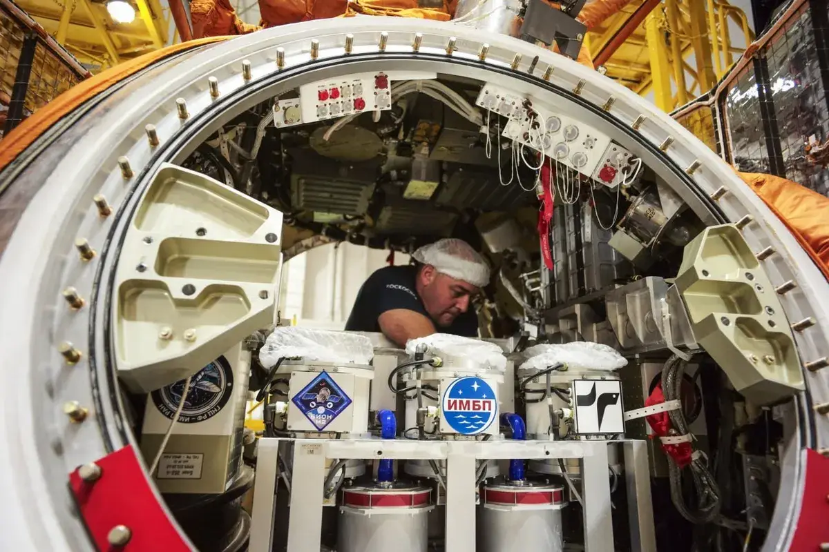 A technician preparing the experiments pre-launch (Roscosmos)