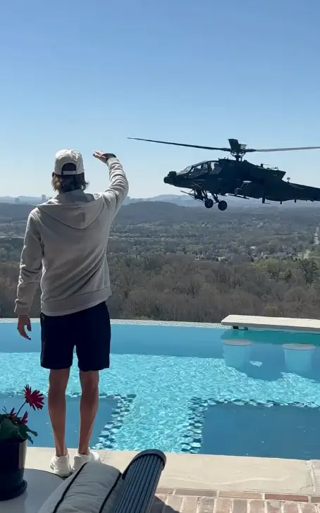 Kid Rock was filmed saluting the Army chopper as it flew past his rooftop pool (Instagram/@kidrock)