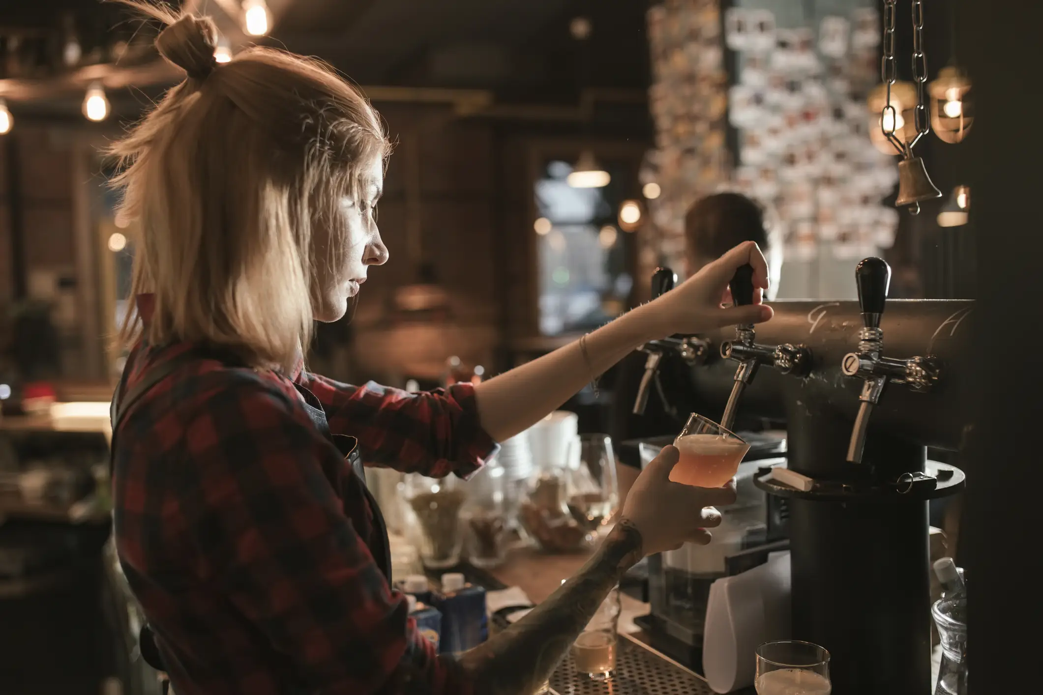 The person pulling your pint on a Friday night is probably trying to make a living while studying at university. (Getty Stock Image)