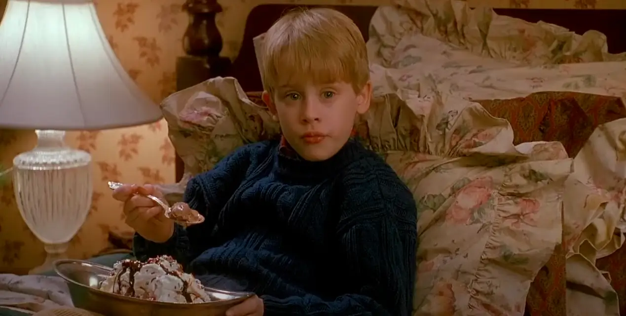 Macaulay Culkin tucked into room service ice cream in Home Alone 2 (20th Century Fox)