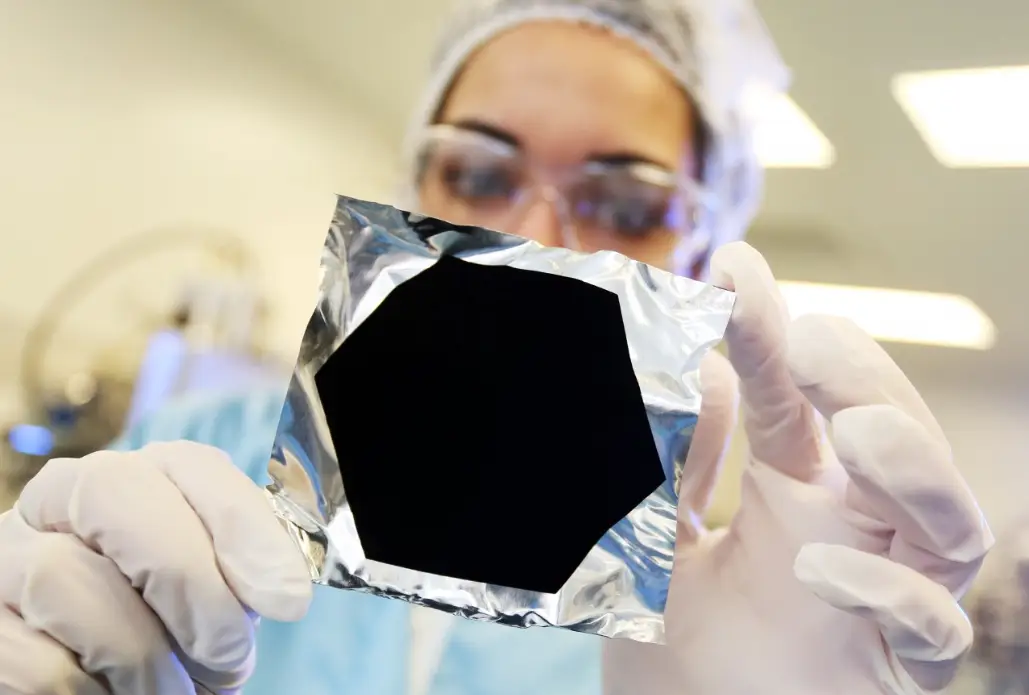A scientist holding up some Vantablack spraypaint. (Surrey NanoSystems)