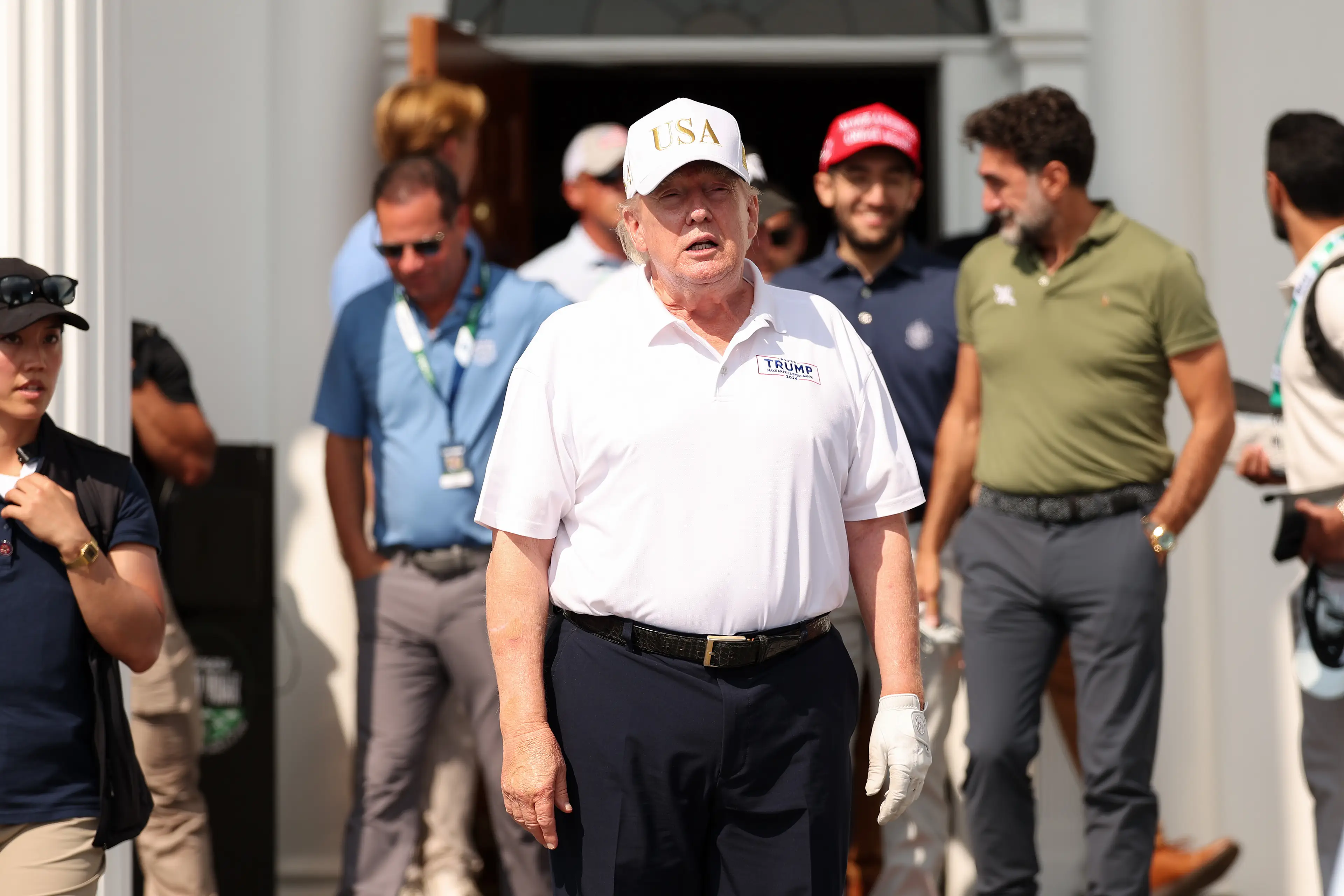 What appears to be bruising on Trump's right arm during a golf event ( Jordan Bank/Getty Images)