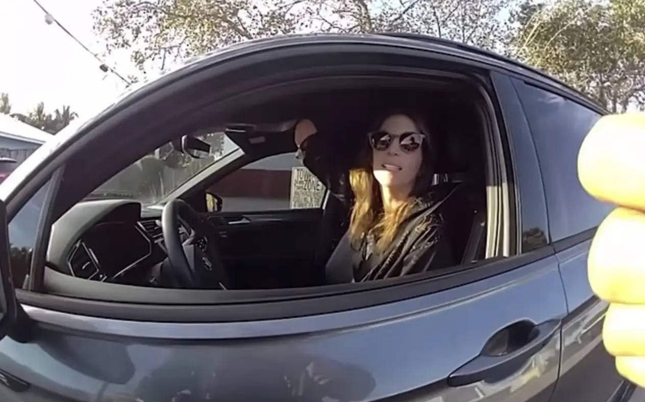 The officer accused Katie of using her phone in her right hand, prompting her to lift her arm up and reveal she only had one hand (CBS)
