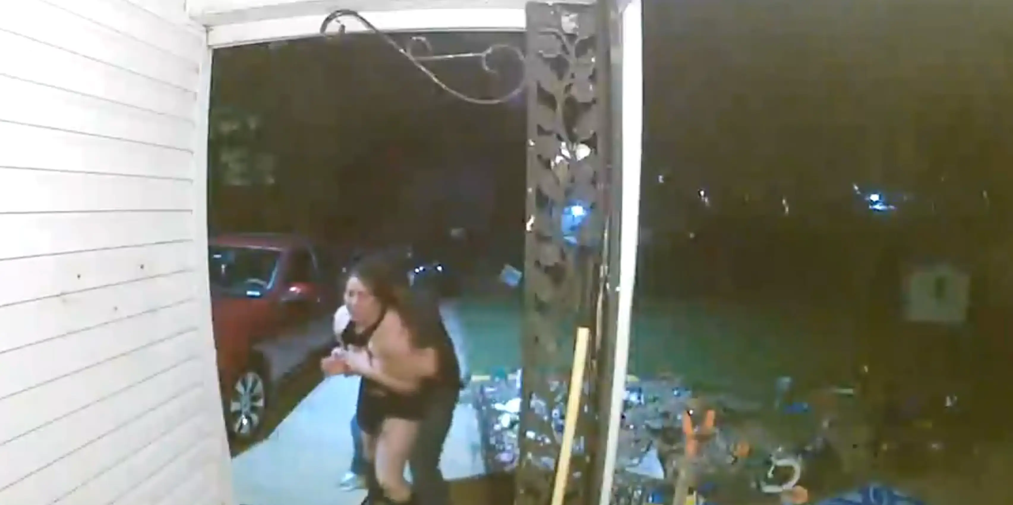 The clip shows an unidentified man forcefully bundling her away as she screams (Wichita Police)