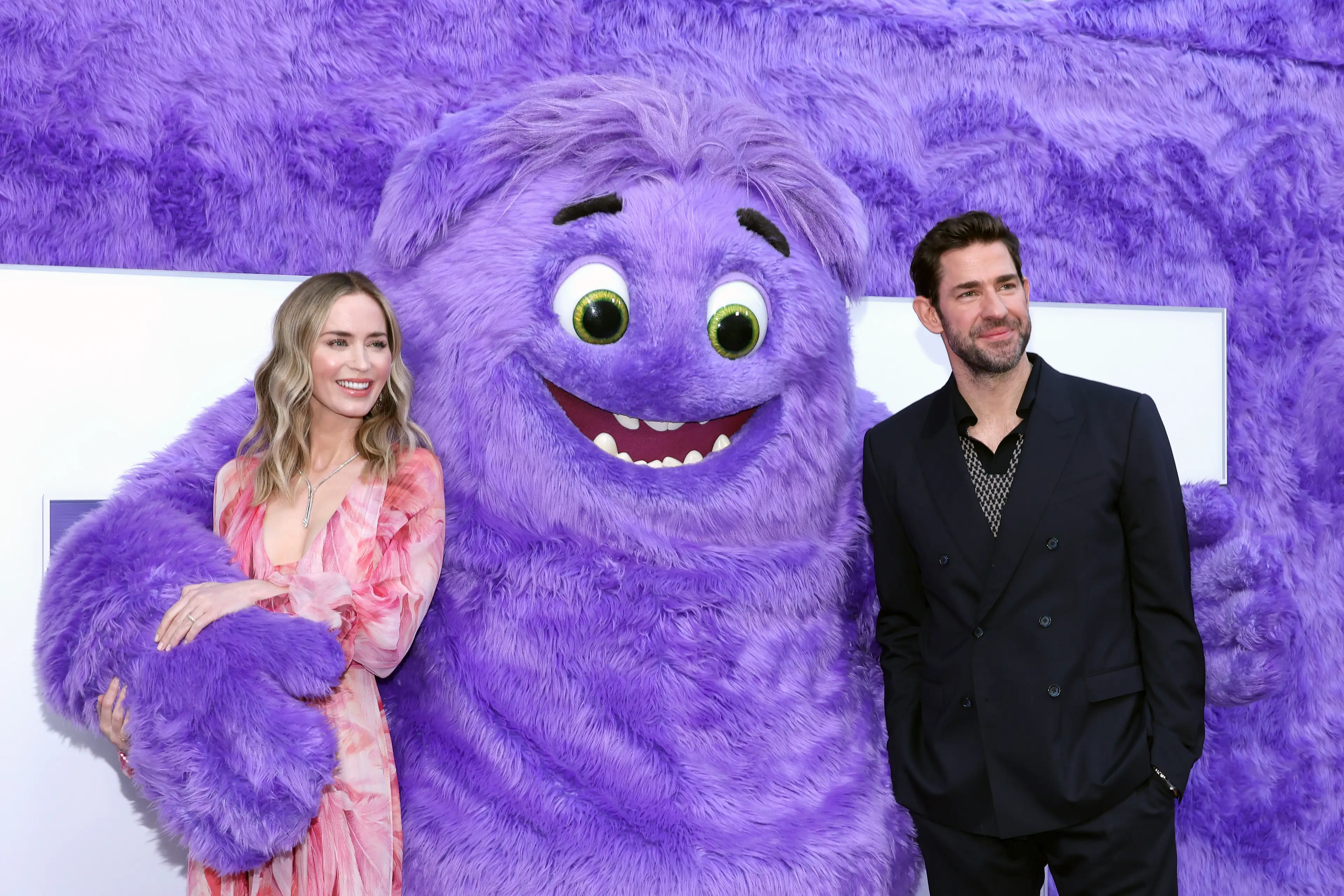 In real life, Emily Blunt is married to The Office star John Krasinski, he's the guy on the right, not the giant purple creature (Mike Coppola/Getty Images)