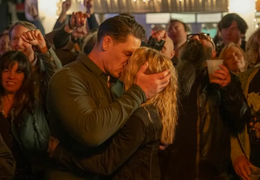 Cena and Holland had to shoot their kiss 'over and over' while Gunn watched on (HBO Max)