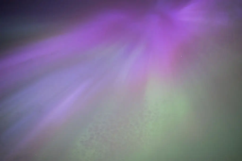 A purple green glow is what many see in the sky (Ian Forsyth/Getty Images)