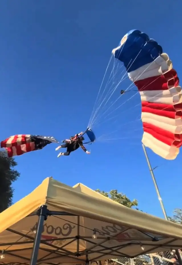 The skydiver's Fourth of July stunt went drastically wrong after the flag he was carrying seemingly got snagged on trees (X)