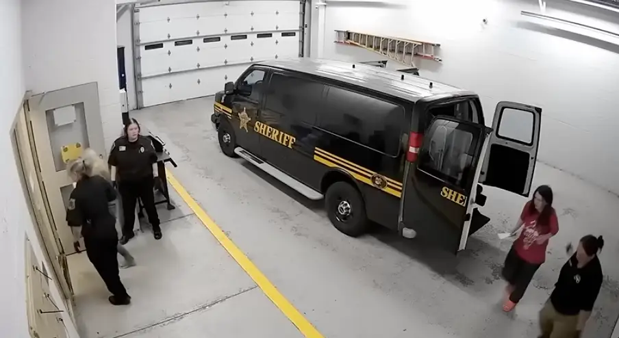Elizabeth led out of the van and into jail (YouTube/CourtTV)