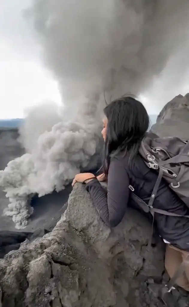 The tourist has come under fire for climbing to the rim of the active volcano in Indonesia (X/@volcaholic1)
