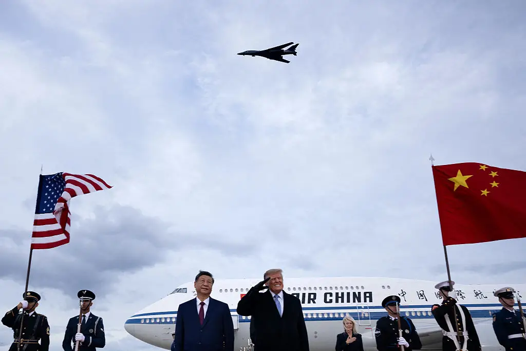 Trump appeared to grimace as the bombers flew overhead (Brendan Smialowski / AFP via Getty Images)