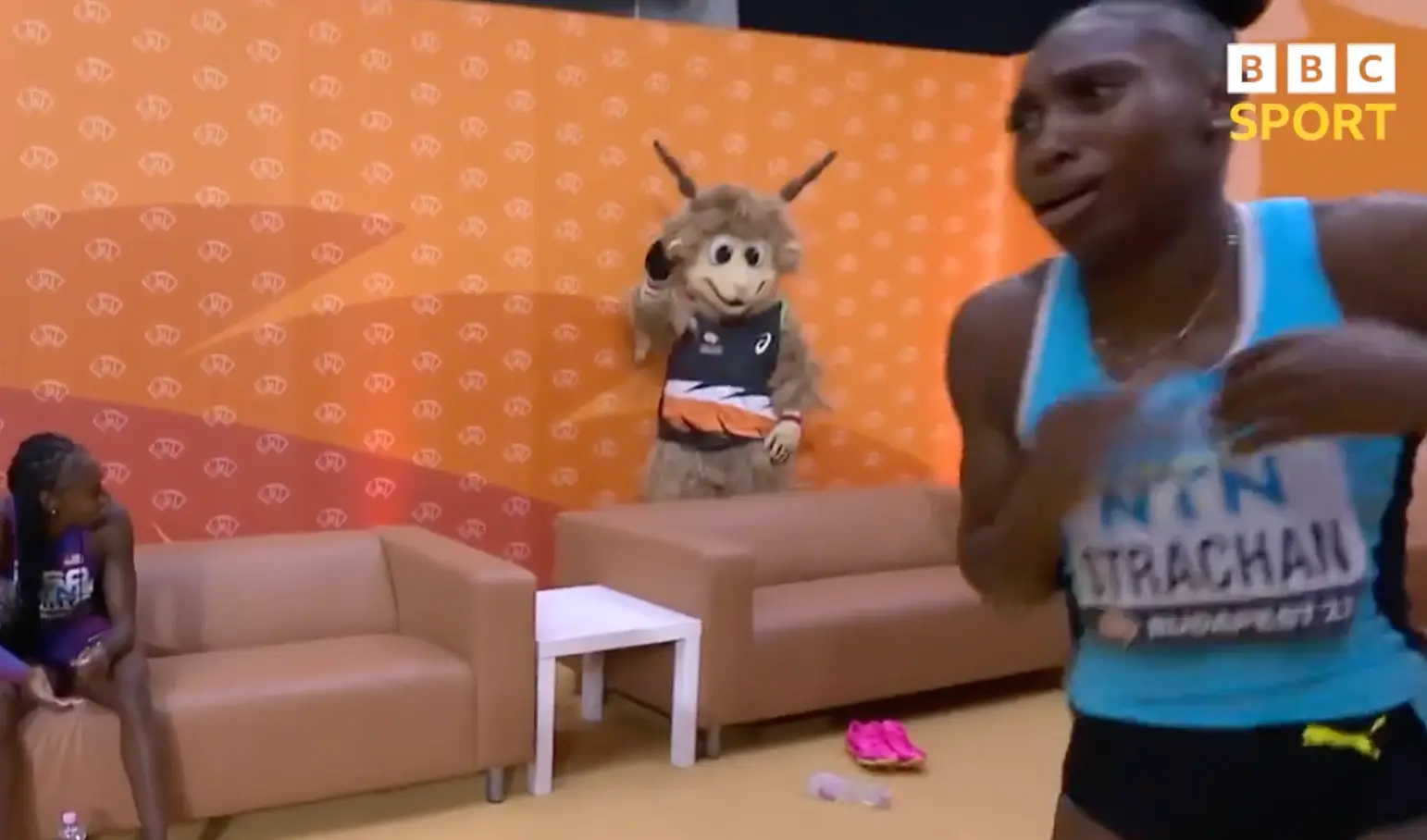 The athlete leapt out of her seat and ran towards the camera.