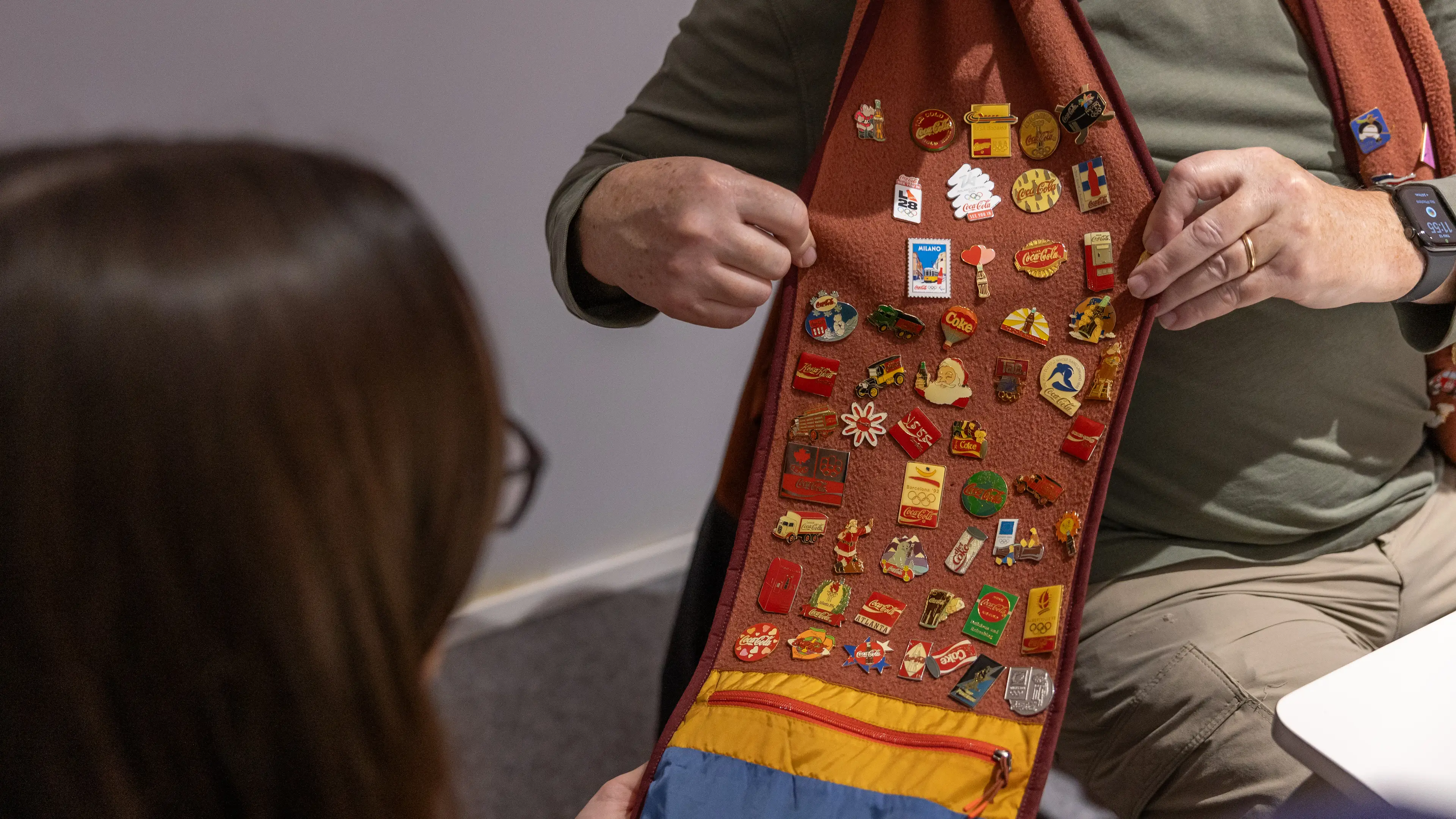 A fan shows off their Coca Cola pin haul at The Peak experience in Milan (Supplied) 