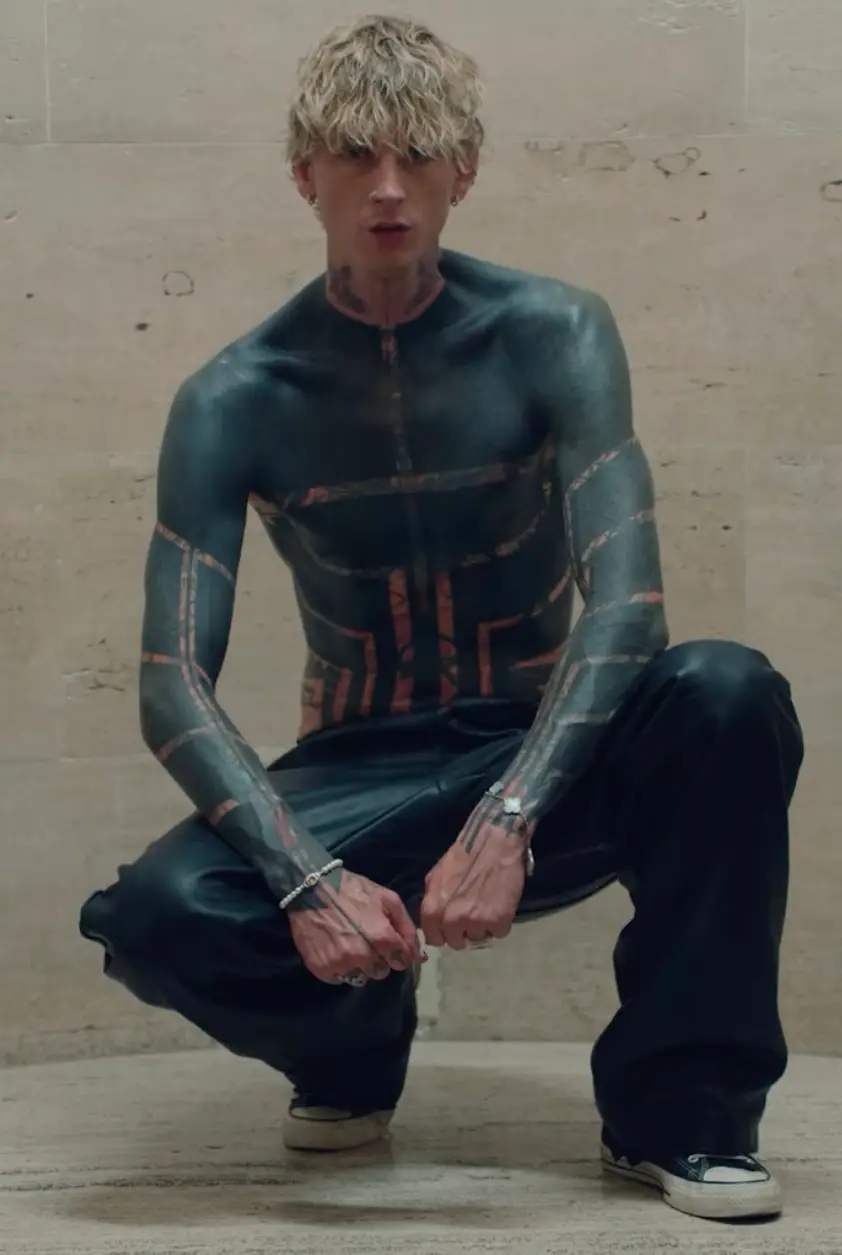 Traina said people tend to opt for blackout tattoos as it is the 'simplest and most cohesive way to start again' (Instagram/@machinegunkelly)