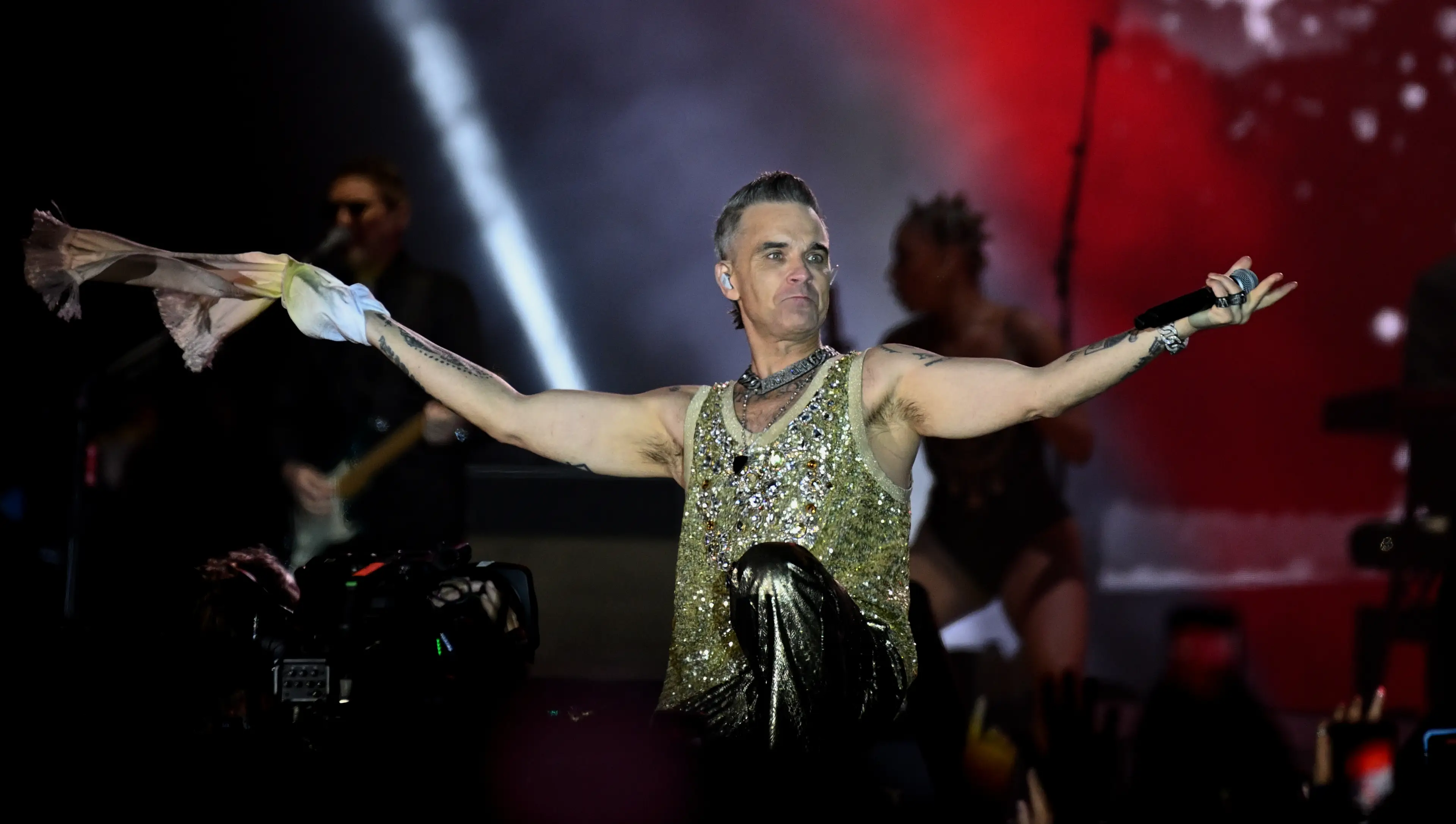 Fans were leaving the concert when the woman fell trying to step over seating rows.