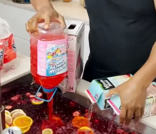 The Tipsy Bartender creating his famous jungle juice in his sink (TikTok / realtipsybartender)