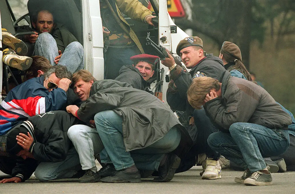 A Bosnian solider returns fire after he and civilians are cornered by a Serbian sniper (MIKE PERSSON/AFP via Getty Images)