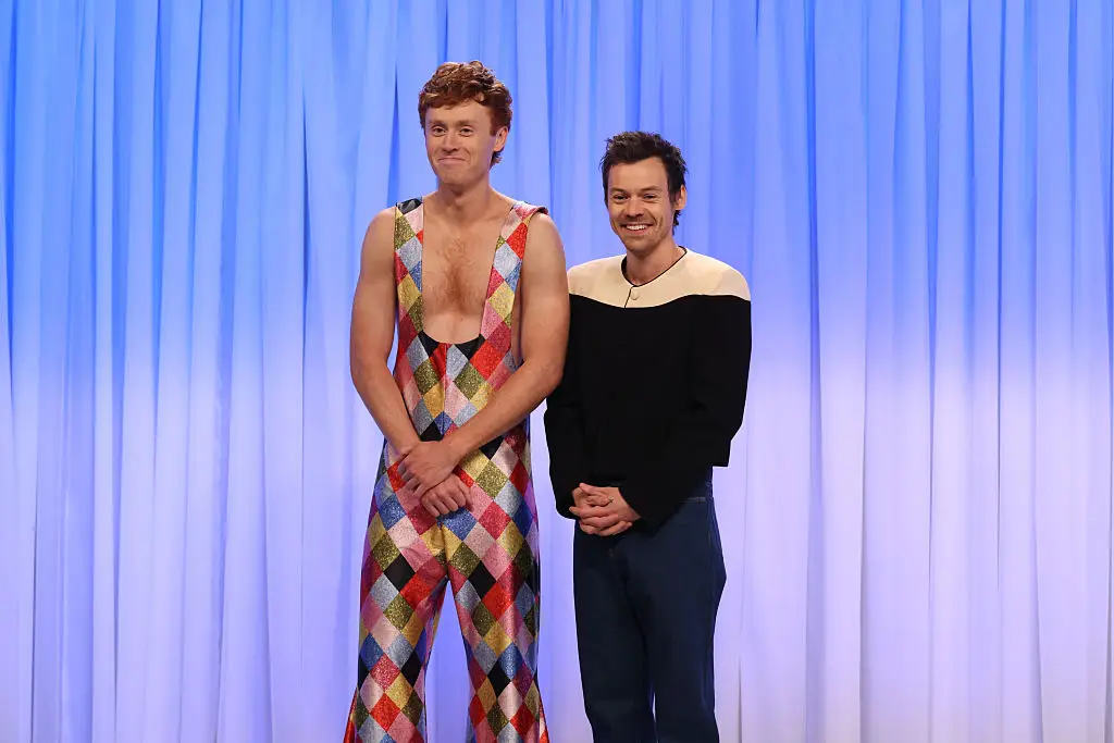 Styles shared a smooch with the SNL writer (Will Heath/NBC via Getty Images)