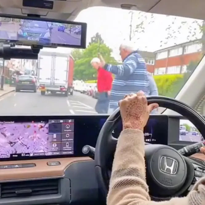 The driver was forced to a stop after the pedestrians approached the road.